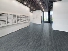 Large empty lobby of an apartment building with lots of mailboxes