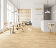 Interior of stylish pub with white and wooden walls, wooden floor, gray sofa, tables and chairs and white bar counter with stools. 3d rendering