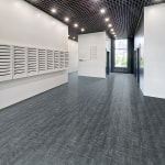 Large empty lobby of an apartment building with lots of mailboxes